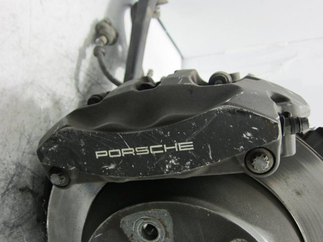 Zacisk hamulcowy tylny lewy 7P0615423 PORSCHE