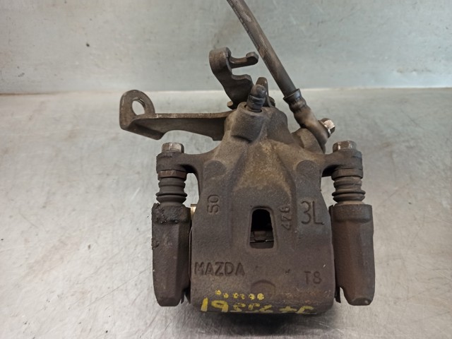 Zacisk hamulcowy tylny lewy K0Y12699ZA MAZDA