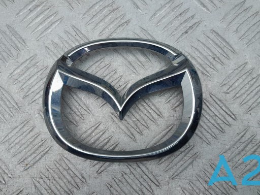 Do koszyka D10J51730 Mazda Emblemat na atrapę chłodnicy